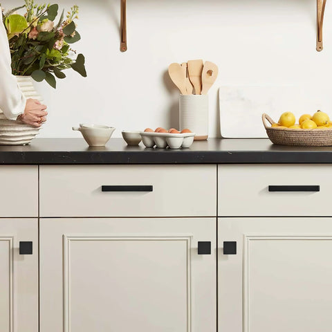 Solid Matte Black 12 Inch Cabinet Handles Set Of 2 For Kitchen Cabinets Drawers And Vanity Doors Heavy Duty Zinc Alloy Hardware With Modern Look And Easy Install shown on white cabinets with black countertop.
