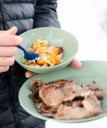 Solo Camp Table Set For One 6 Piece Plastic BPA Free Mess Kit with food on plate and bowl outdoors