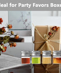 Four Pack 5ml Glass Jars With Lids Tiny Mini Bottles For DIY Crafts Storage And Decor Screw Cap Containers next to a wrapped gift