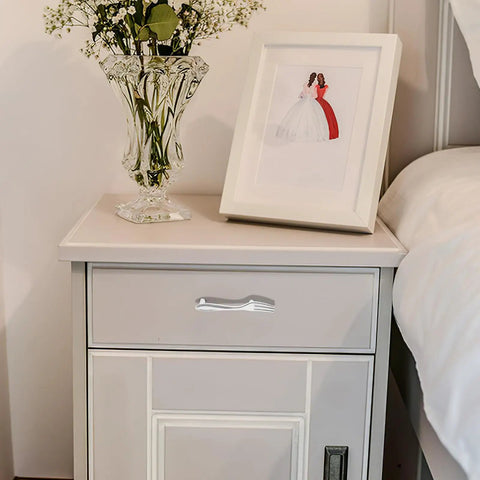 Chrome Plated Cabinet Handles And Drawer Pulls 3 Piece Set For Kitchen Cabinets Wardrobe And Furniture Replacement With Single Hole Modern Hardware Pulls In European Style on a white nightstand with floral decor.