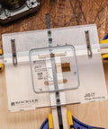 Q4 Small Quadrant Hinge Mortise Template For Router Jig on wooden surface with clamps, showing clear acrylic design with guide markings.