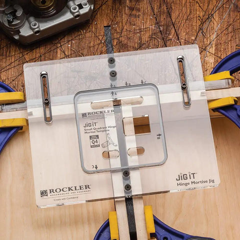 Q4 Small Quadrant Hinge Mortise Template For Router Jig on wooden surface with clamps, showing clear acrylic design with guide markings.