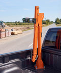 VEVOR 1100 Lb Electric Truck Crane For Pickup Bed With Foldable Telescopic Boom and 360 Rotation in orange mounted on truck bed.