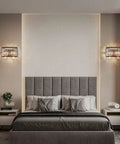 Modern Matte Black Flush Mount Wall Sconce With Radiant K9 Crystals And Sleek Led Fixtures For Hella Cozy Bedroom Ambiance And Living Room Swag Vibe Across Every Spot above a gray upholstered bed.