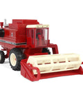 Front view of International Harvester 1460 Combine Die Cast Model One Sixty Fourth Scale With Rear Wheel Assist And Interchangeable Four Row Corn Head And Grain Head For Collectors Authentic Die Cast Metal Replica showcasing corn head attachment.