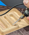 Hand using 24 Piece Wood Carving Drill Bits Set For Rotary Tools Engraving Kit With 3mm Shank Pro Grade Corundum Bits on wood