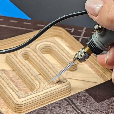 Hand using 24 Piece Wood Carving Drill Bits Set For Rotary Tools Engraving Kit With 3mm Shank Pro Grade Corundum Bits on wood