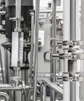 Installed view: 2-inch 304 stainless steel sanitary check valve with tri-clamp ferrules on a vertical pipe.
