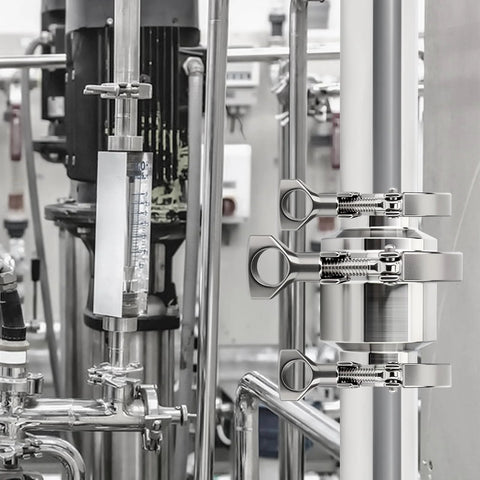 Installed view: 2-inch 304 stainless steel sanitary check valve with tri-clamp ferrules on a vertical pipe.