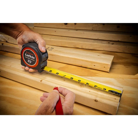 Pro Grade 1-3/16 Inch By 35 Foot Tape Measure With Anti Pinch Retract being used on wooden planks for precise measurement.