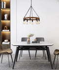 Round Wagon Wheel Chandelier With Eight Lights in dining room, rustic farmhouse pendant fixture, openwork wood and faux rust metal.