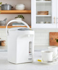 Your Go To 3L Hot Water Dispenser With Slow Drip Mode For Coffee And Tea on kitchen countertop near cups and saucers
