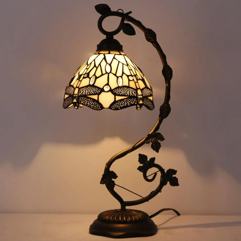 Amber Tiffany Style Dragonfly Table Lamp With Stained Glass Shade And Metal Leaf Base, lit with warm ambient light