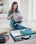 Woman organizing clothes into Heavy-Duty Clear Storage Bags With Zipper, 12 Pack, 12L Waterproof Moving Organizer Bags on carpet.