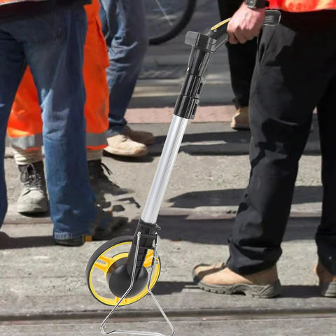 Jiawu Digital Display Distance Measuring Wheel Foldable Hand Push Roller Rangefinder on construction site for accurate measurement.
