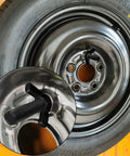 Spare Tire Holder Mount For E Track Rails, Easy Install Off Floor Tire Carrier For Enclosed Trailers shown with wheel and bolt detail.