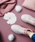 White Self Adhesive Sneaker Repair Patches For Fresh Kicks Instant Heel Hole Fix displayed beside pastel sneakers on pink surface.