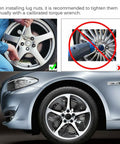 Manual tightening of lug nuts on a car wheel using torque wrench, related to Beefy M14x1.5 Wheel Lug Stud Nut Set for Cars and SUVs.