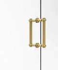 Back-To-Back Shower Door Pull 8-Inch With Twisted Accent In Unlacquered Brass mounted on glass door