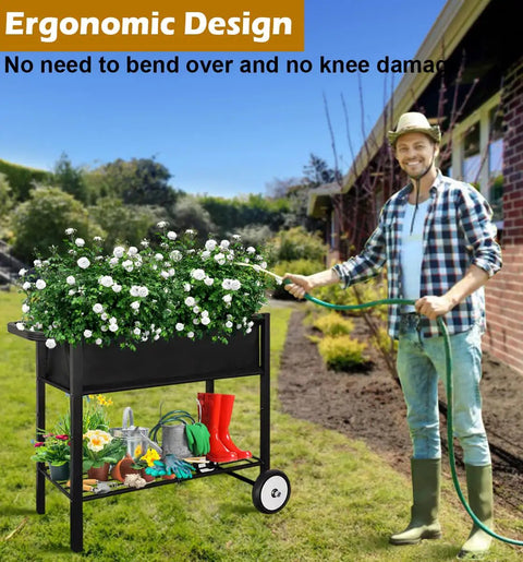 Raised Garden Bed On Wheels With Legs 31 Inch Elevated Outdoor Planter Cart For Vegetables Flowers Tomatoes Herbs Ergonomic Design Movable Garden Bed With Heavy Duty Handle Black, displayed on a lawn with gardener nearby.