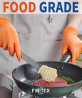 Orange nitrile disposable gloves (FINITEX) worn while cooking in a frying pan.