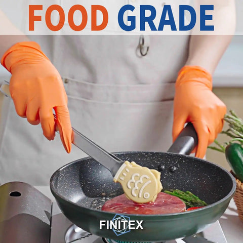 Heavy Duty Nitrile Disposable Gloves In Bright Orange Boasting Tough As Nails Tear Resistance And A Slick Comfort Fit Built For Kitchen Chores Auto Detailing And Garage Grind 100 Pack Box holding a spatula in a frying pan.