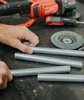 Heavy Duty 6061 Aluminum Spacer 5/8 OD X 5/16 ID X 36 Inch Long Unthreaded Round Standoff Bushing Rock Solid For M8 Nuts And Bolts 10 Pack arranged on a workshop table with tools.