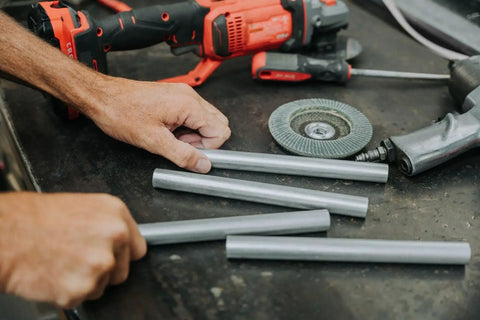 Heavy Duty 6061 Aluminum Spacer 5/8 OD X 5/16 ID X 36 Inch Long Unthreaded Round Standoff Bushing Rock Solid For M8 Nuts And Bolts 10 Pack arranged on a workshop table with tools.