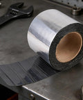 Heavy Duty Asphalt Sealing Tape Self Adhesive Waterproof Patch With Aluminum Foil for roof repairs on a workbench.