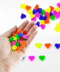 Hand holding colorful heart shape beads from 210 Pcs Bike Wheel Spokes Beads Set For Kids - Colorful Plastic Clip Beads