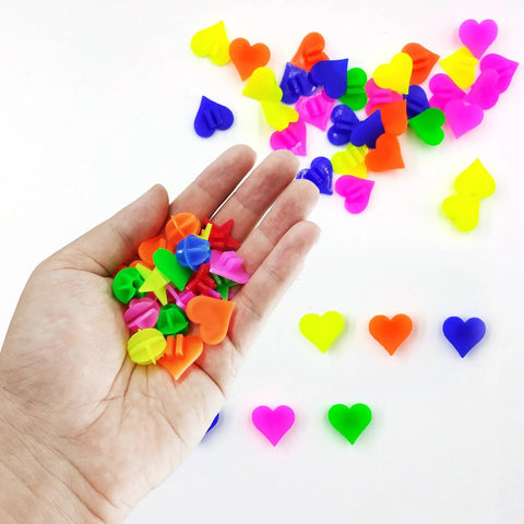 Hand holding colorful heart shape beads from 210 Pcs Bike Wheel Spokes Beads Set For Kids - Colorful Plastic Clip Beads