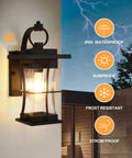 Dusk To Dawn Outdoor Wall Lantern With Sensor, Matte Black Porch Light, shown lit on house exterior with weatherproof features