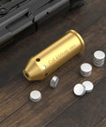 Bore Sight For 44 Magnum Caliber With Red Dot Laser Sight Class IIIA Less Than 5mW Bright Red Laser and batteries on table.