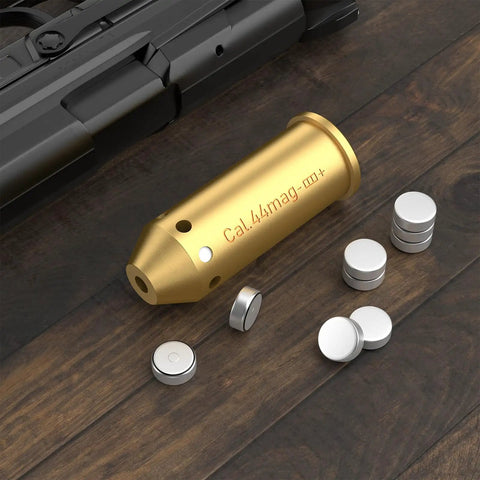 Bore Sight For 44 Magnum Caliber With Red Dot Laser Sight Class IIIA Less Than 5mW Bright Red Laser and batteries on table.