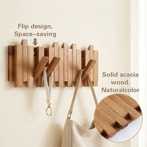 Premium Acacia Wood Wall Mounted Coat Rack With Eight Retractable Hooks, Space Saving Flip Down Entryway Stand, Zero Drama Install And Heavy Duty Grip For The Daily Grind with folded hooks and a bag.