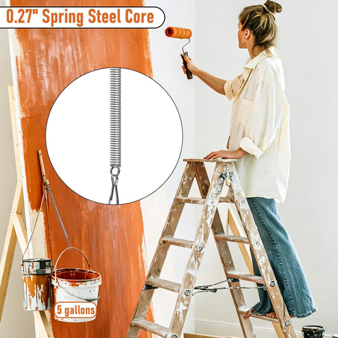 Close-up of a 0.27 inch spring with woman painting in background. Bulk 15 Pack Heavy Duty Extension Springs 5 Inch By 0.27 Inch Stainless Steel Tension Springs With Hooks For Screen Doors Recliners Pets Crafts And Furniture Rustproof And Built To Stretch Up To 11.8 Inches