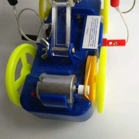 Hands On Solar Kinetic Energy Demonstration Trolley For Science Education Drivable Solar Car Model That Converts Sunlight To Motion blue plastic and metal motor close-up