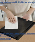 Person wiping a Black Single Serve Coffee Maker Cover For K-Supreme And K-Compact Pods with cloth on table