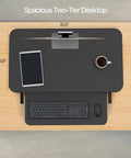 Top view of the Height Adjustable 32 Inch Desk Converter with keyboard tray and items, showcasing dual monitor riser for home office.