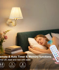 Must Have Battery Operated Wall Sconce Set Of 2 With Pleated Fabric Shade In Gold shown with remote control feature