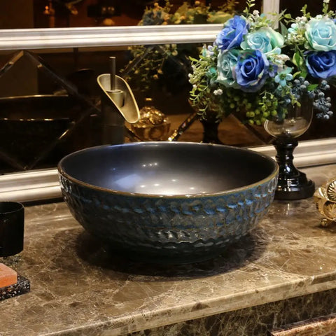 USZWBY Vessel Sinks Bathroom Vessel Sink Round Ceramic Washbasin on marble countertop with faucet.