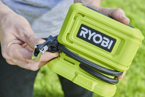 Close-up of hands holding 18V One Plus Cordless Tire And Ball Inflator With Mini Compressor 11 Bar Max Fast Inflation To 32 PSI In Under A Minute