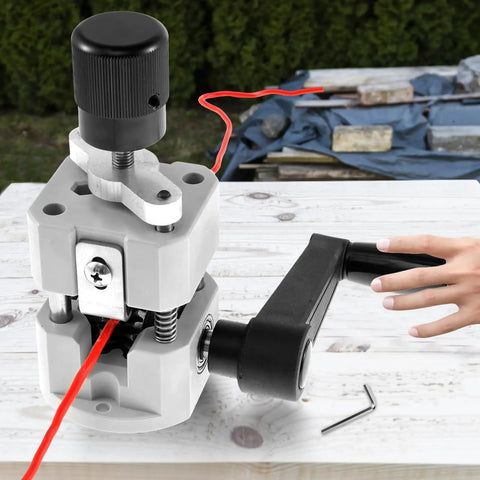Hella Tough Manual Drill Powered Wire Stripper Machine For Copper Cable Recycling portable device stripping red wire on wood surface.
