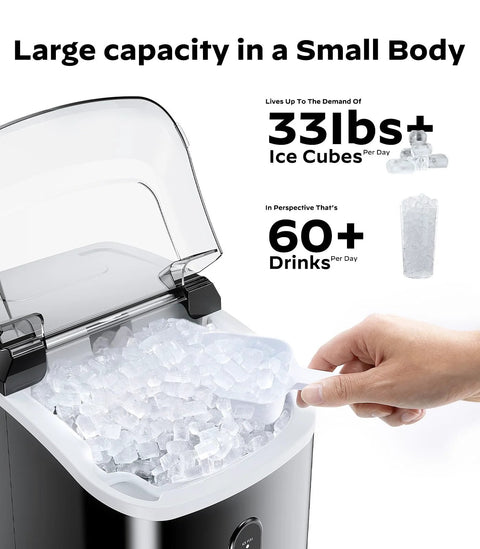 Black countertop nugget ice maker with a clear lid; hand scooping ice pellets from the bin.