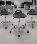 Built Tough Height Adjustable Shop Stool With Smooth Rolling Swivel Casters And A Durable Pu Seat Ready For Assembly Lines Cleanrooms And Garage Workspaces. Three stools in an office setting.