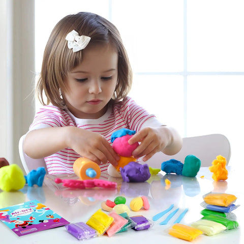 Child playing with Air Dry Clay Kit For Kids With 90 Colors And Tools DIY Modeling Clay Set on table