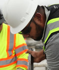 Construction workers wearing Ridgeline Full Brim Hard Hat With 4 Point Ratchet Suspension Lightweight ABS Build.