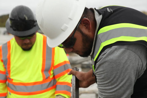 Construction workers wearing Ridgeline Full Brim Hard Hat With 4 Point Ratchet Suspension Lightweight ABS Build.