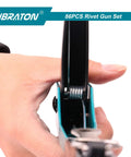 Close-up of hand holding a Heavy Duty Rivet Gun Kit With Four Interchangeable Heads for metalwork and automotive use.