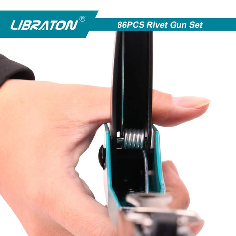 Close-up of hand holding a Heavy Duty Rivet Gun Kit With Four Interchangeable Heads for metalwork and automotive use.